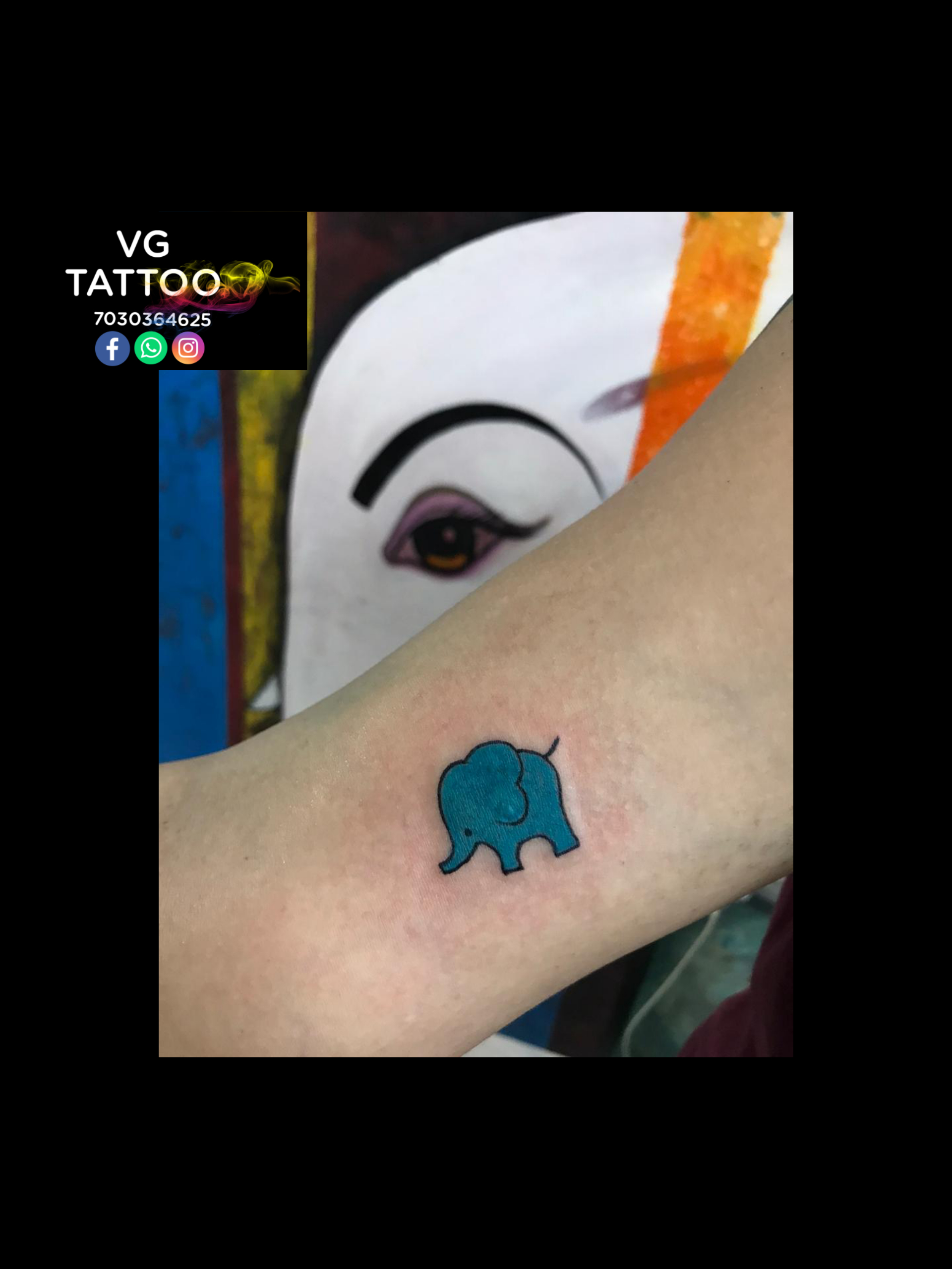 One-line blue eye elephant tattoo on the inner forearm